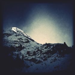 Scenic view of snow covered mountains against sky