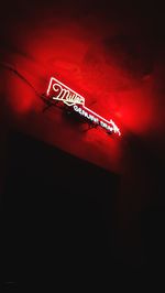 Low angle view of illuminated text on wall