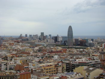 High angle view of modern buildings in city against sky