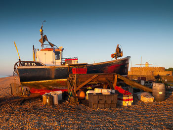 View of red boat on footpath against clear sky