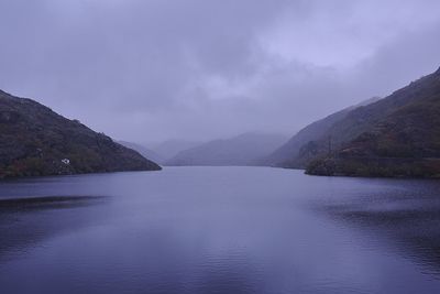 Scenic view of lake against cloudy sky
