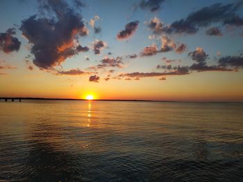 Scenic view of sea against romantic sky at sunset