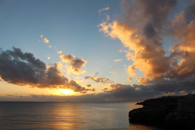 Scenic view of sea against sky at sunset