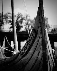 Close-up of boat moored against sky