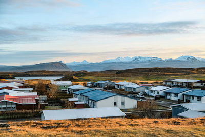 Houses on field against sky