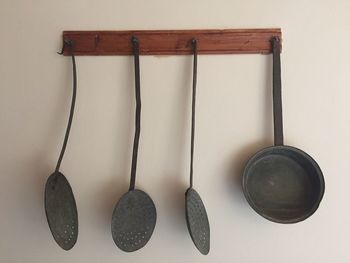 Close-up of kitchen utensils hanging on wood