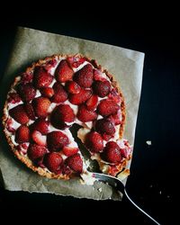 High angle view of strawberry tart on wax paper