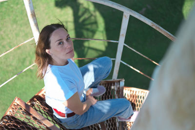 Pretty mid age woman sitting on stairs of old lighthouse. real people. travel and sightseeing