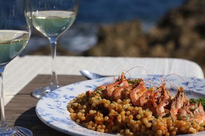 Close-up of seafood with white wine on table