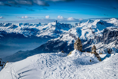 Scenic view of snowcapped mountains against sky