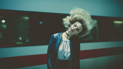 Beautiful woman standing against train