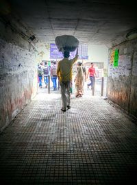 Full length of woman standing in tunnel