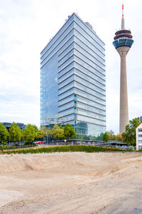 View of modern building against cloudy sky