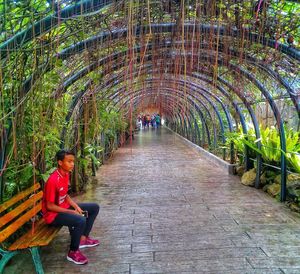 Man sitting on bridge