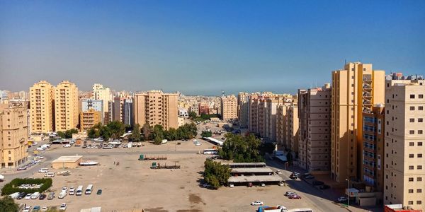 View of city street and buildings against sky