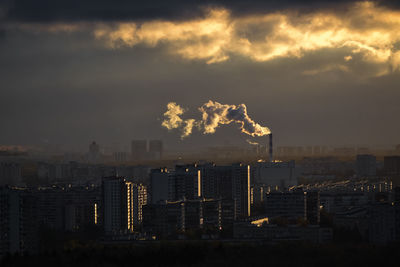 Smoke emitting from chimney against sky at sunset