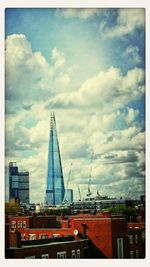 View of construction site against cloudy sky