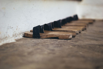 Close-up of wood on table against wall