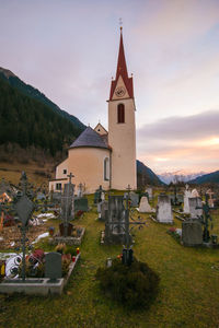 Little church with cemtery in the center of racines at sunrise