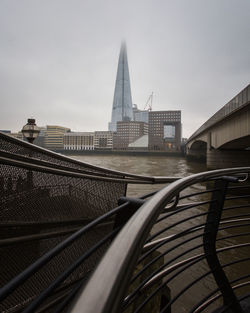 Bridge in city against sky