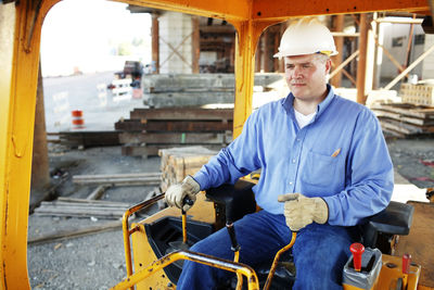 Male construction foreman sitting in a construction loarder