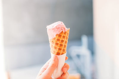 Close-up of hand holding ice cream