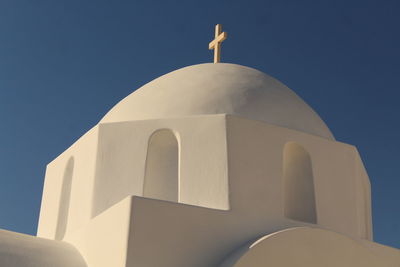 Low angle view of cross on building against sky