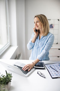 Smiling businesswoman working at office