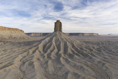 View of desert against cloudy sky