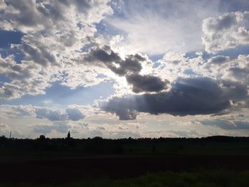 Scenic view of silhouette field against sky during sunset