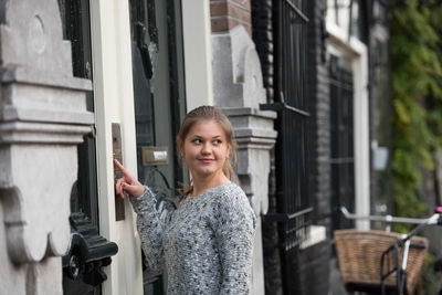 Woman entering code to open door