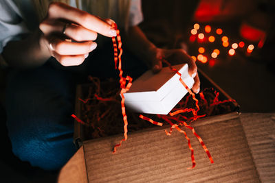 Woman open gift during video call on laptop computer