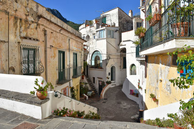 A narrow street between old buildings in albori, a village in amalfi coast, italy. 