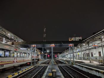 Train at railroad station against sky at night