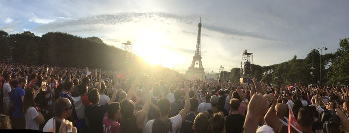 Panoramic view of crowd watching soccer on screens at eiffel tower