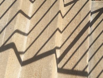 High angle view of shadow on tiled floor