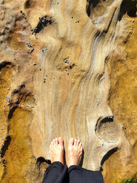 Low section of person standing on rock