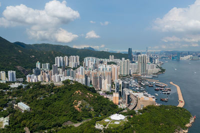 High angle view of buildings by sea against sky