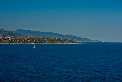 Scenic view of sea against clear blue sky