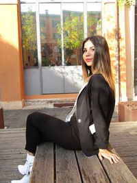 Portrait of young woman sitting outdoors