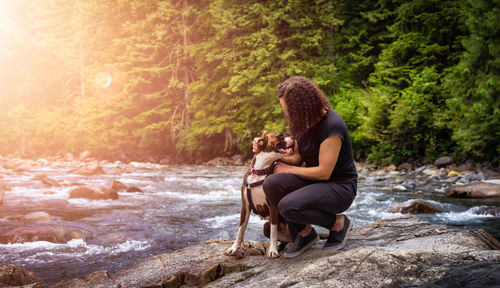 Rear view of women sitting on shore