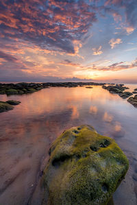 Scenic view of sea against sky at sunset