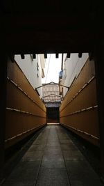 Empty alley amidst buildings in city