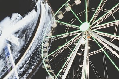 Low angle view of ferris wheel at night