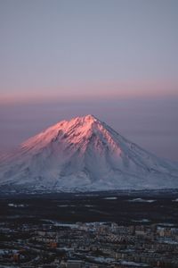 Scenic view of snowcapped mountains against sky during sunset