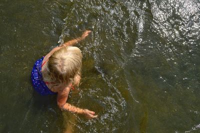 Directly above shot of girl swimming in lake