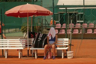 Full length of woman standing on bench