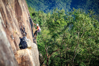 Woman climbing on rocky mountain