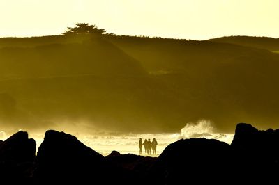 Scenic view of silhouette mountains against sky at sunset