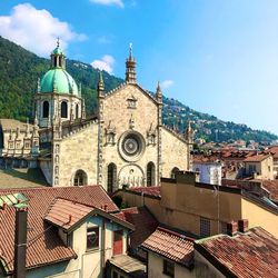 Cathedral and houses in town against sky